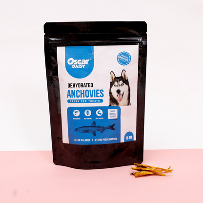 Packaged dehydrated anchovy dog treats with Oscar Daisy branding on a pink background
