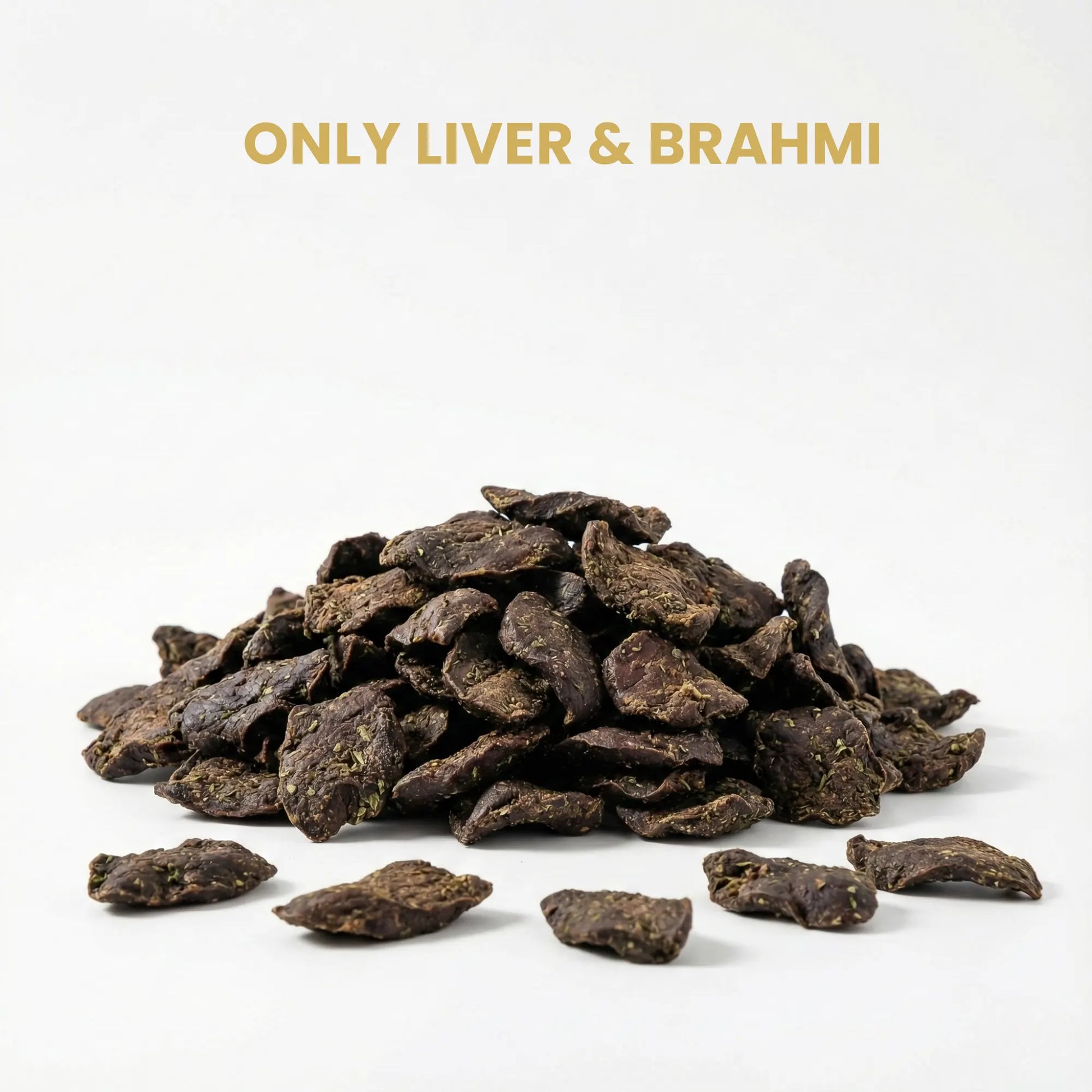 Heap of dark brown dog treats labeled 'Only Liver & Brahmi' on a white background