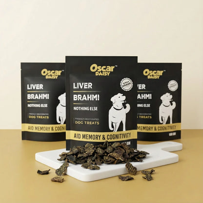 Oscar Daisy dog treats packaging with treats on a white board against a beige background