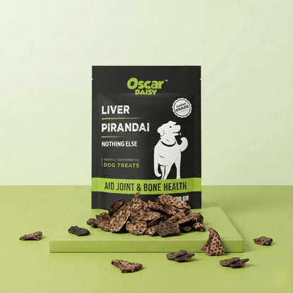 Oscar Daisy Liver Pirandai dog treats pouch on green pedestal with dehydrated liver and pirandai pieces in front, pastel green studio background