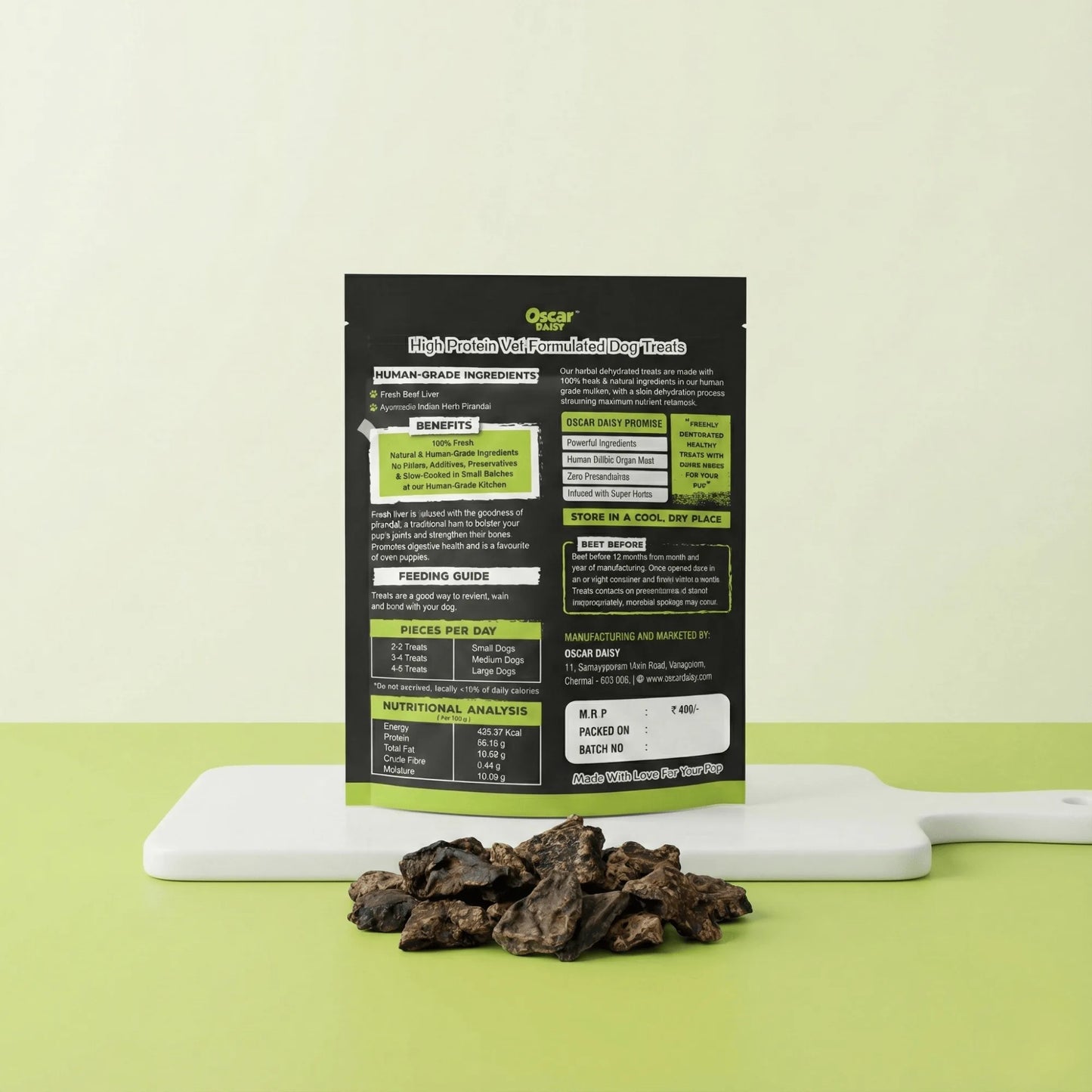 Back side of Oscar Daisy Liver Pirandai dog treats pouch showing ingredients, feeding guide and nutrition information with treats on white board and green background